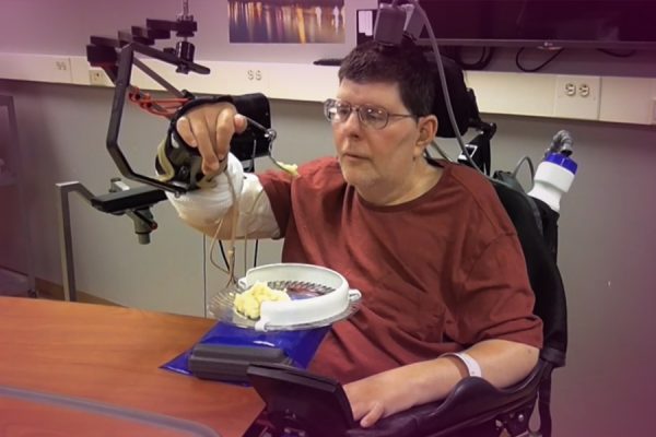 Paralyzed man uses experimental device